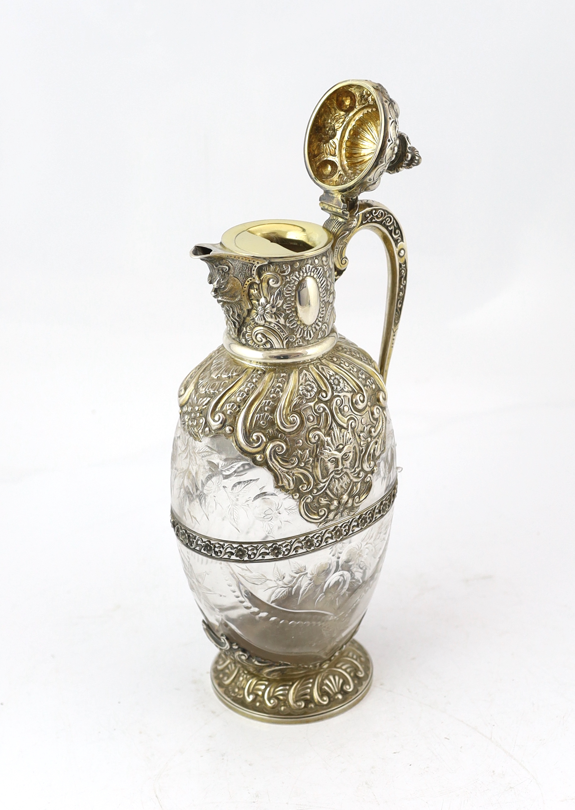 An ornate late Victorian silver mounted cut glass claret jug, by Charles Edwards